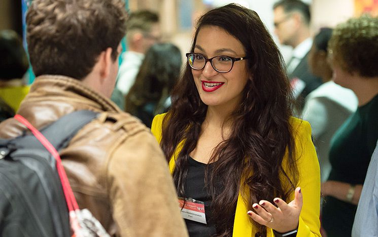 Two people talking at a Make It Happen university careers event