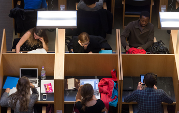 Students studying at booths in the library