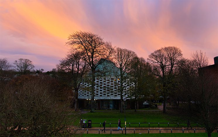 The meeting house against a purple and orange sunset
